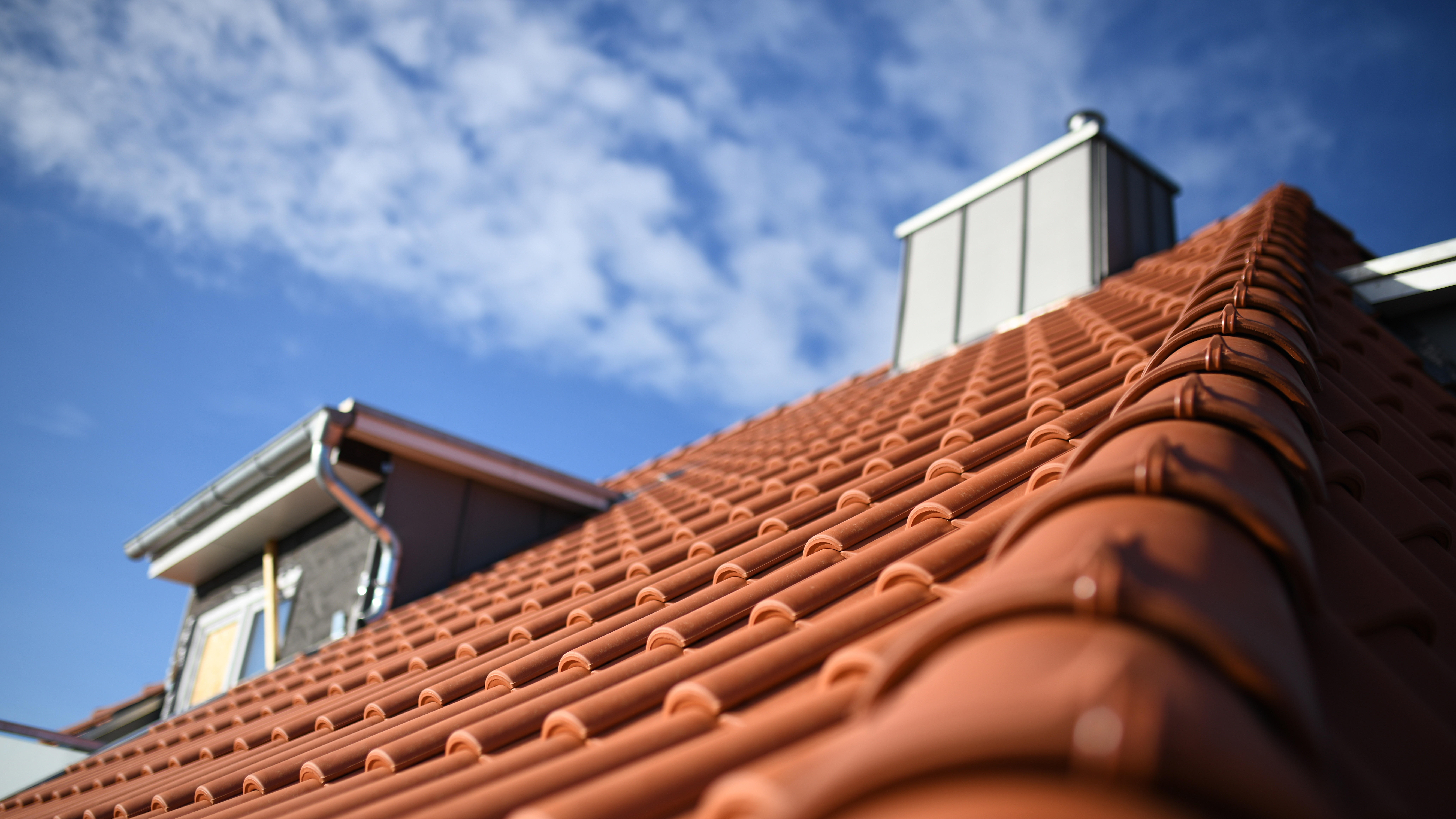 A residential roof with red clay tiles