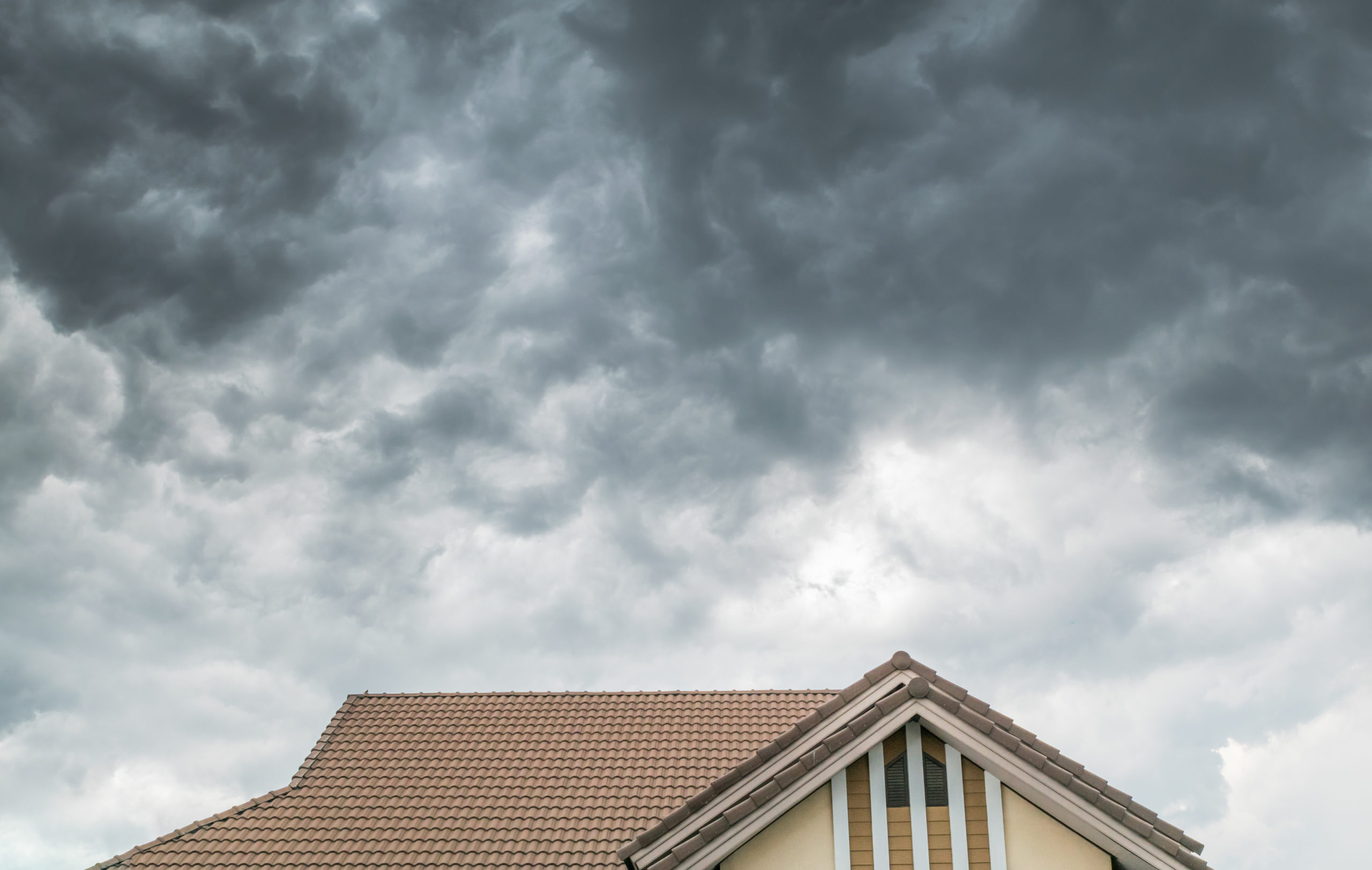 Dark storms clouds form over a residential home