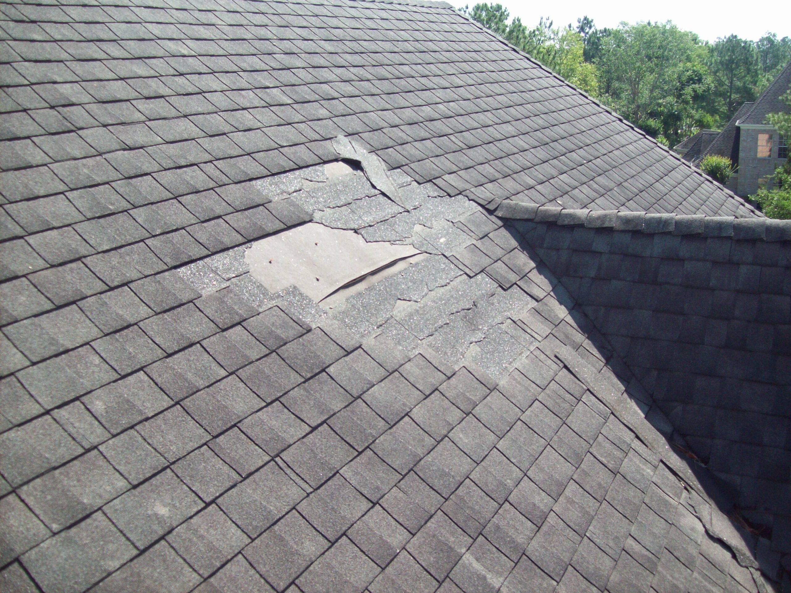 A residential roof that is missing shingles