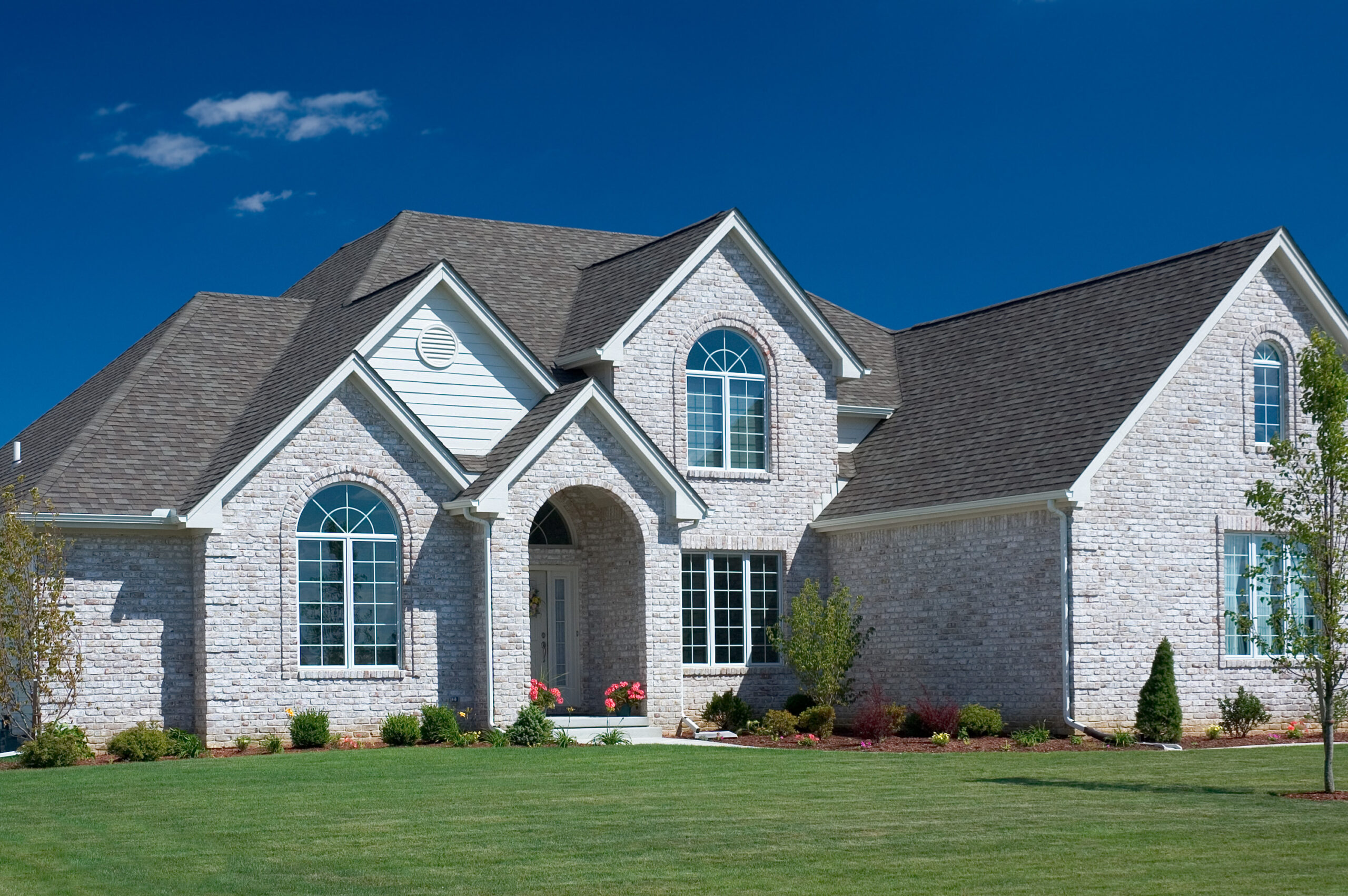 Stone house with an asphalt shingle roo
