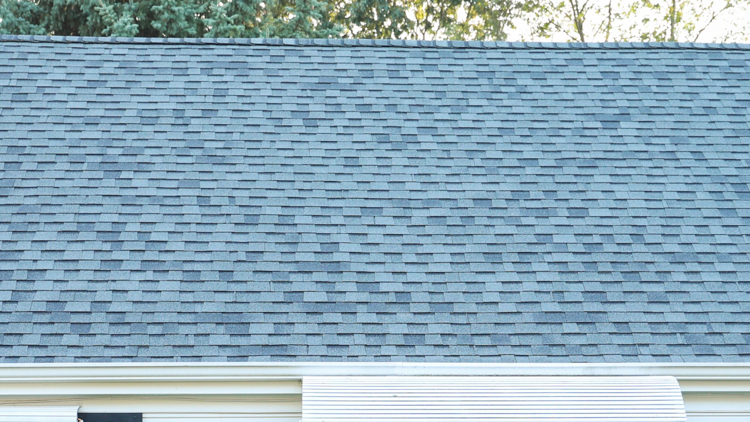 Close-up of home roof with black roofing shingles on it