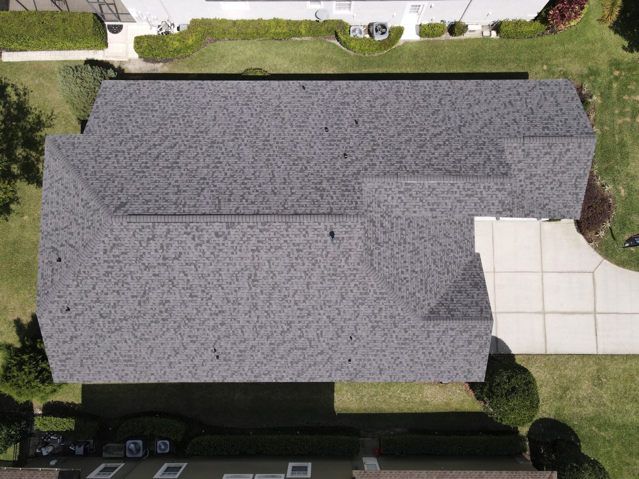 Aerial view of a home with gray asphalt shingle roof
