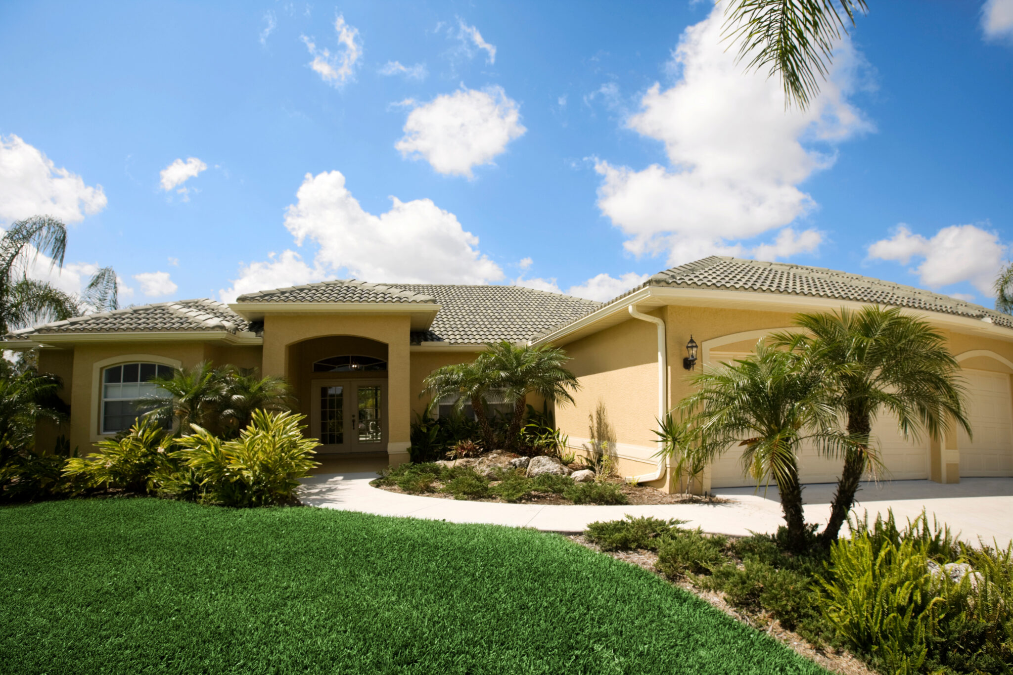 Yellow stucco house with tile roof