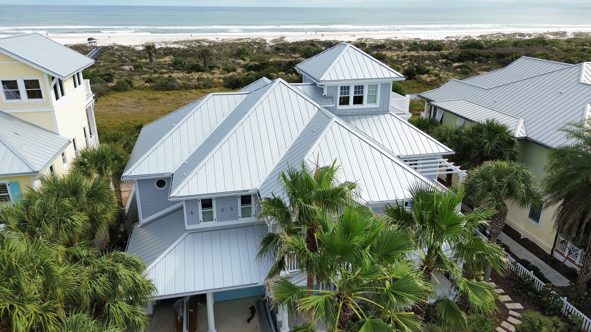 Home with large bright metal roof on it