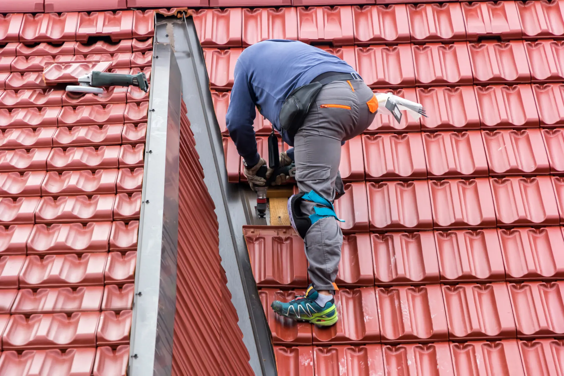 Universal Roof & Contracting Roofer repairing a tile roof In Fernandina Beach, FL call us for all your roofing services