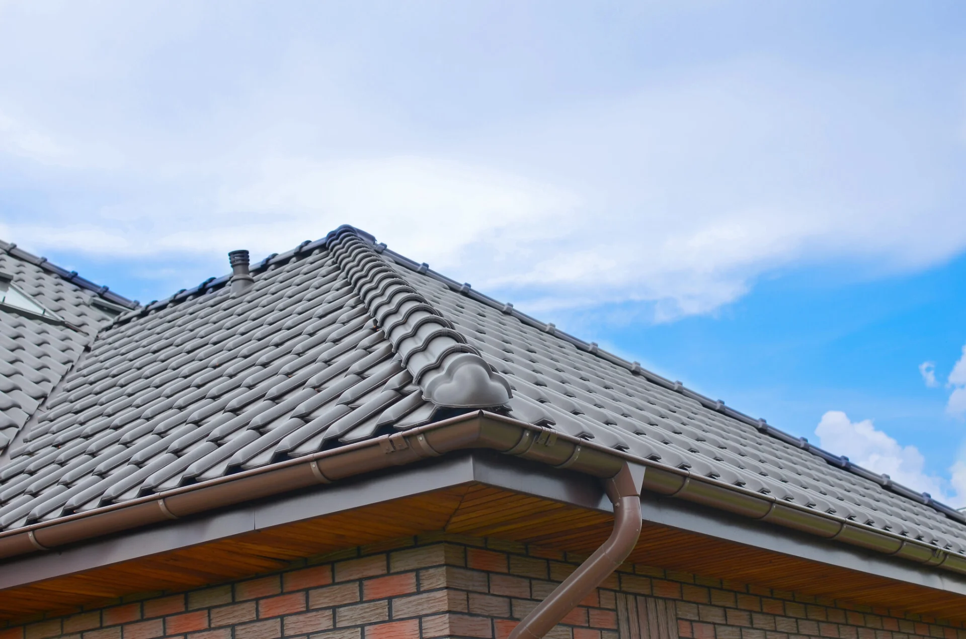 Brown tile roof on a brick house by Universal Roof and Contracting in Fernandina Beach, FL