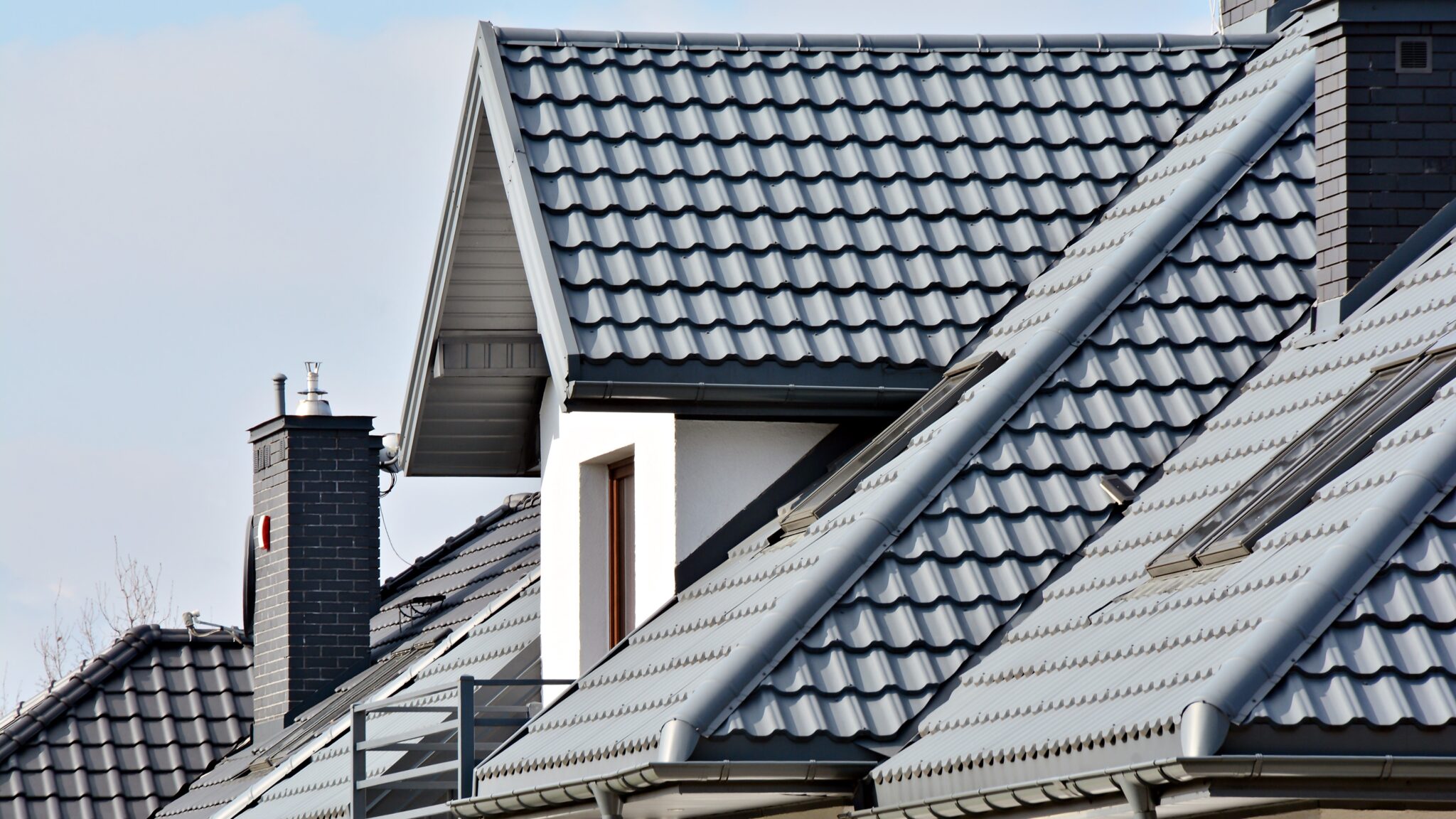 Line of homes with gray stone-coated steel roofing