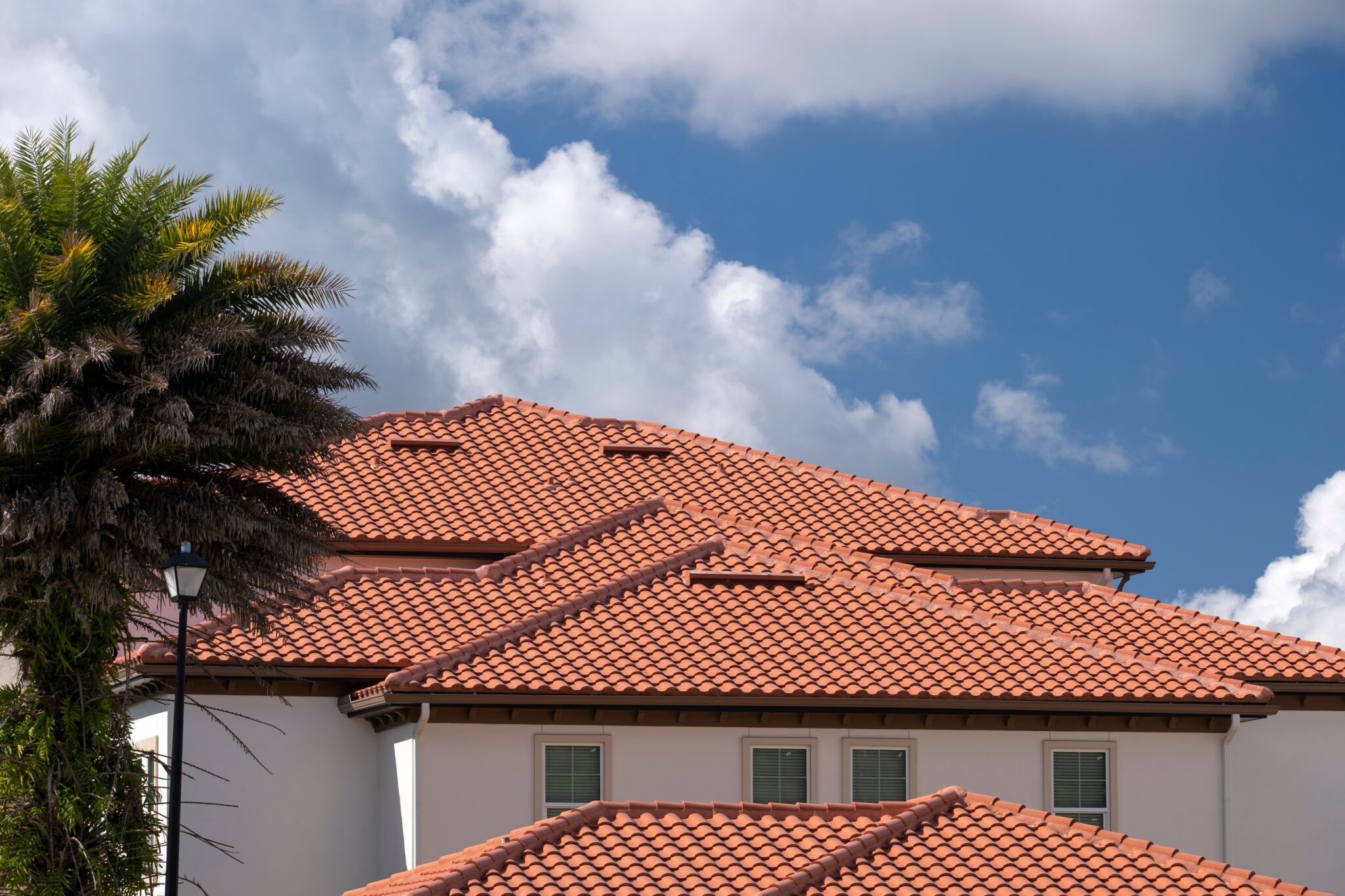 Large home with spanish tile roofing