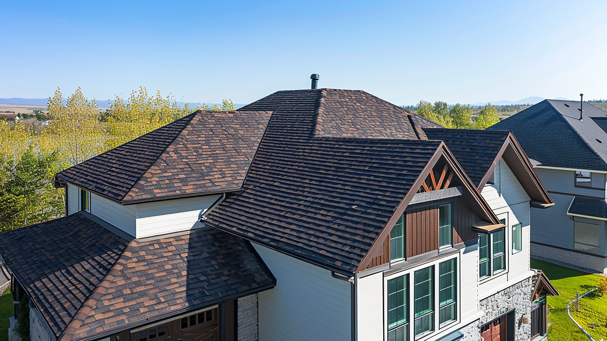 Large home with brown asphalt shingle roofing