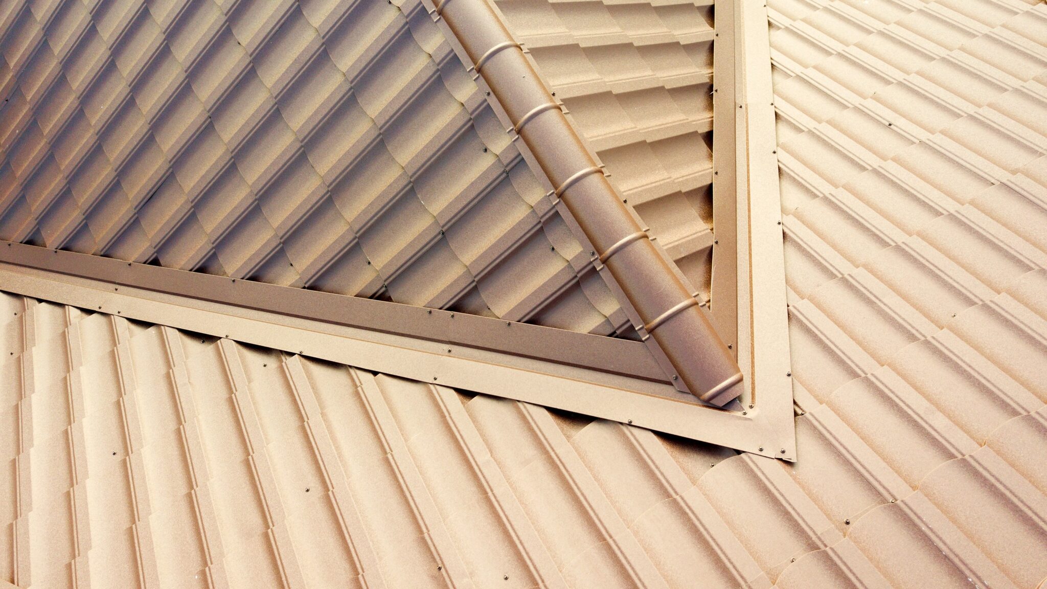 Close-up of tan metal roof ridgetop