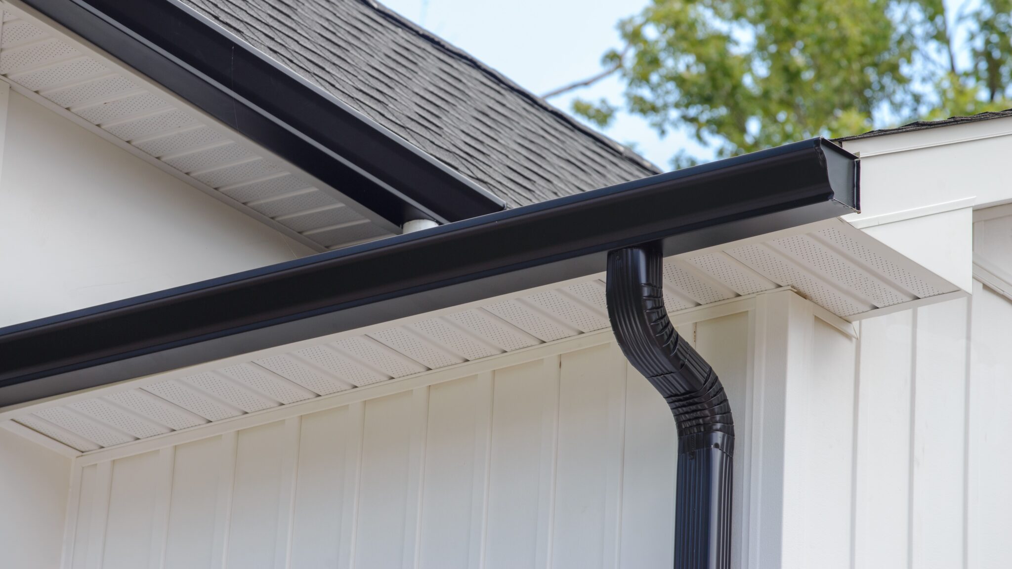 Home corner with new gutters, soffit, and fascia installation