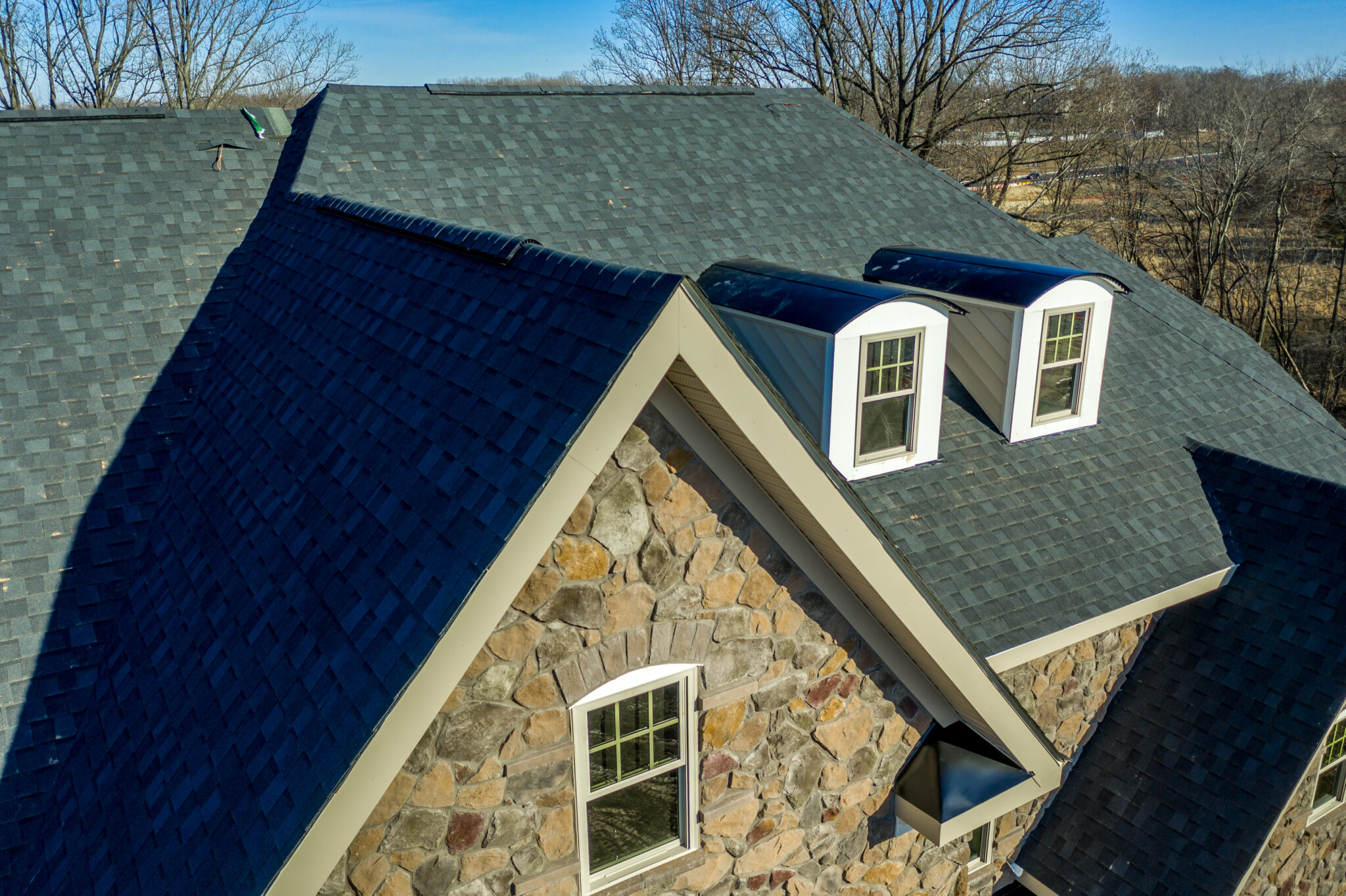 Aerial image of a new pitched roof with triangle gable and asphalt shingles