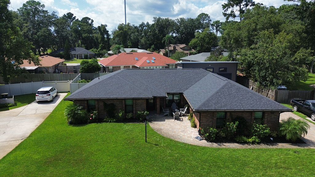 Black asphalt roof on brick residential home