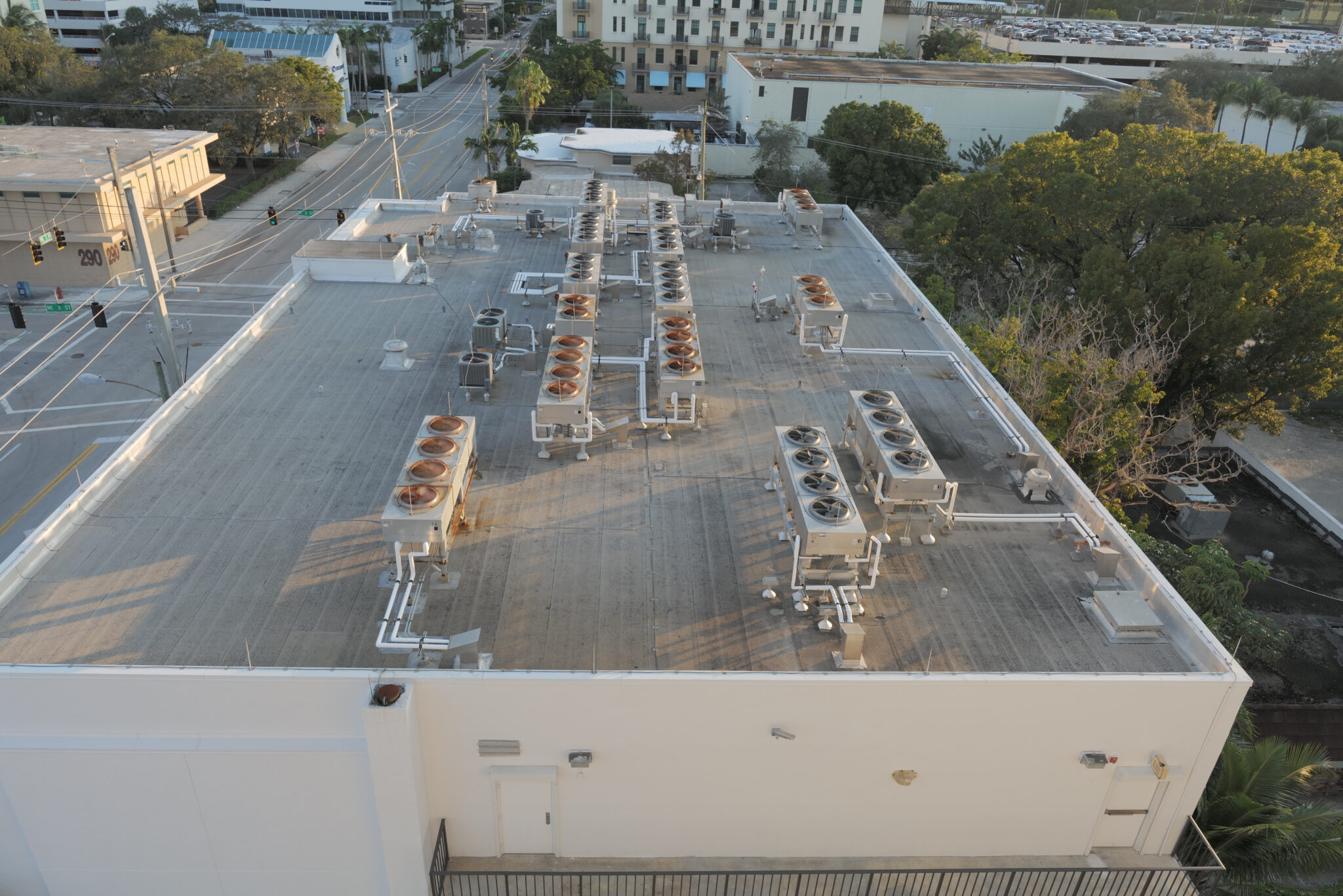 An aerial view of a commercial roof with air conditioning units on it