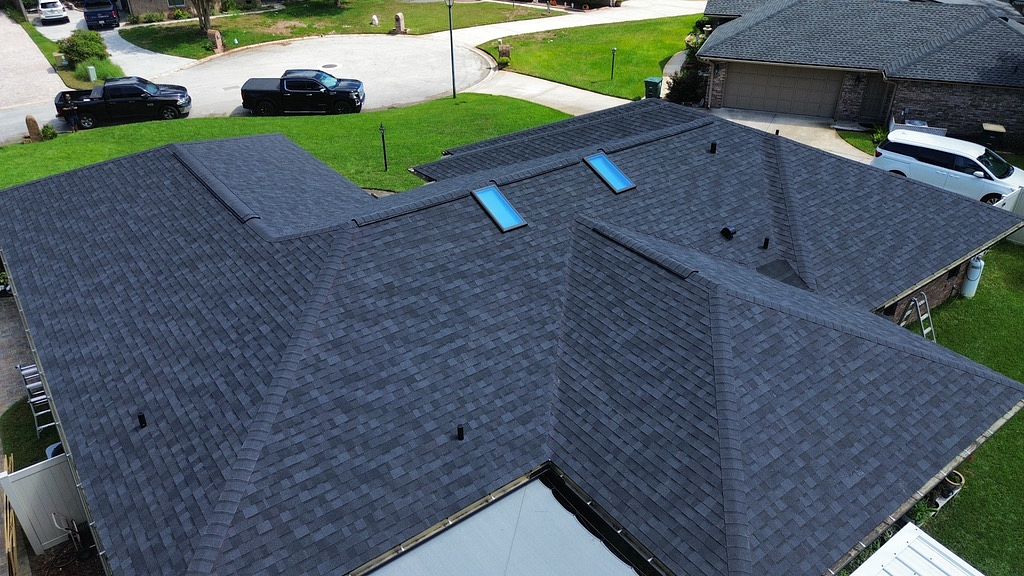 Aerial view of a single family home with an asphalt shingle roof